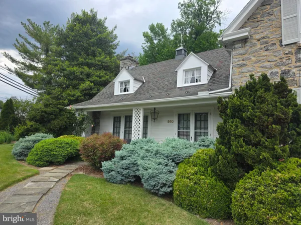 a aerial view of a house with a yard and potted plants