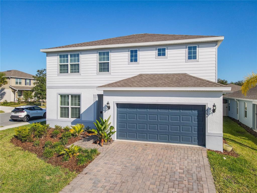 a front view of a house with garden
