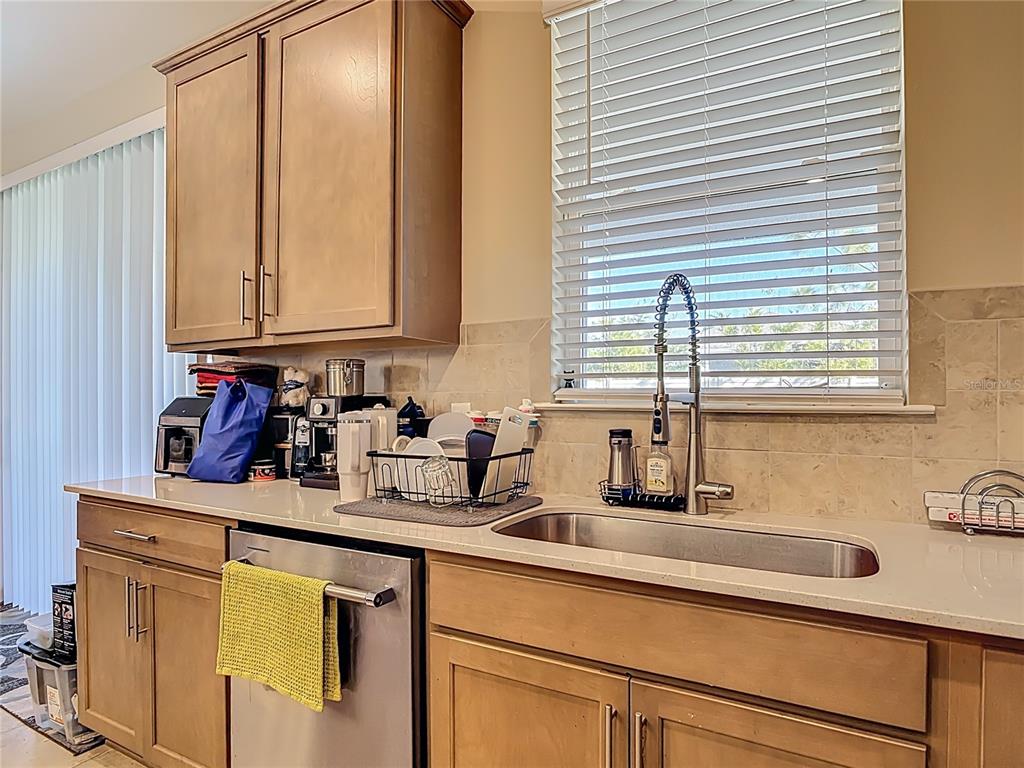 2248 Canopy Terrace Boulevard DeLand, FL 32724 - Photo 11 of 49 a kitchen with sink cabinets and window