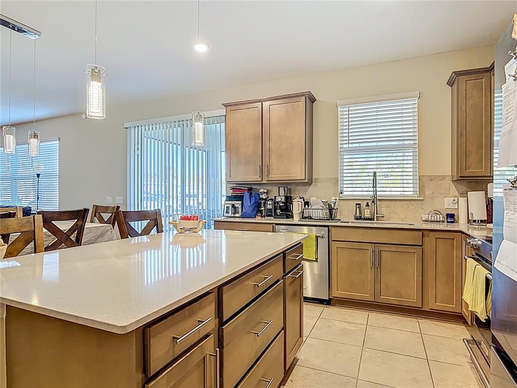 2248 Canopy Terrace Boulevard DeLand, FL 32724 - Photo 12 of 49 a kitchen with stainless steel appliances granite countertop a sink counter space and a window