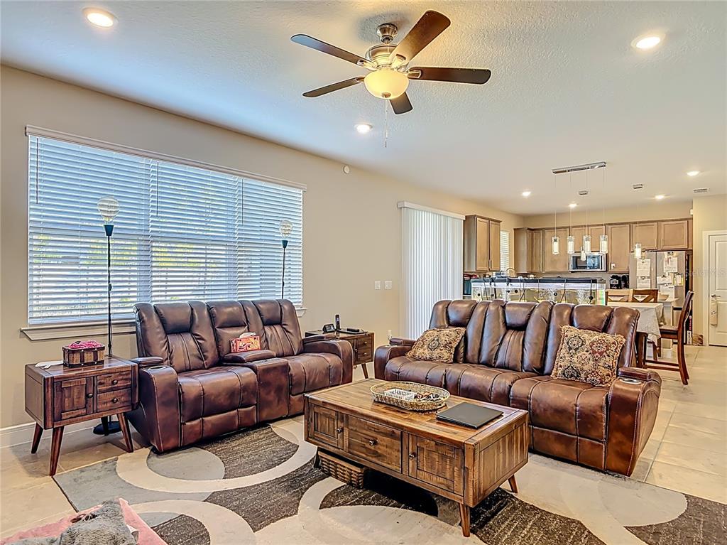 2248 Canopy Terrace Boulevard DeLand, FL 32724 - Photo 15 of 49 a living room with furniture ceiling fan and a rug