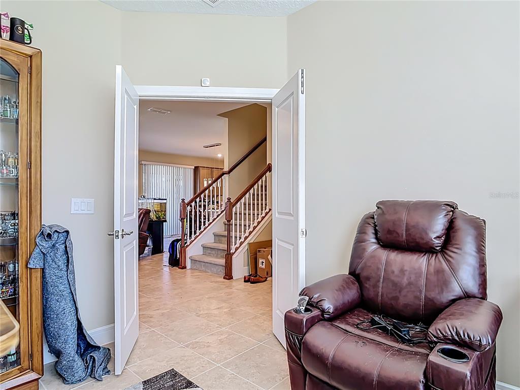 2248 Canopy Terrace Boulevard DeLand, FL 32724 - Photo 17 of 49 a living room with furniture and a potted plant