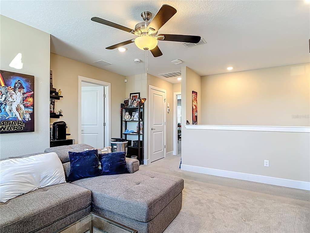 2248 Canopy Terrace Boulevard DeLand, FL 32724 - Photo 19 of 49 a living room with furniture and a ceiling fan