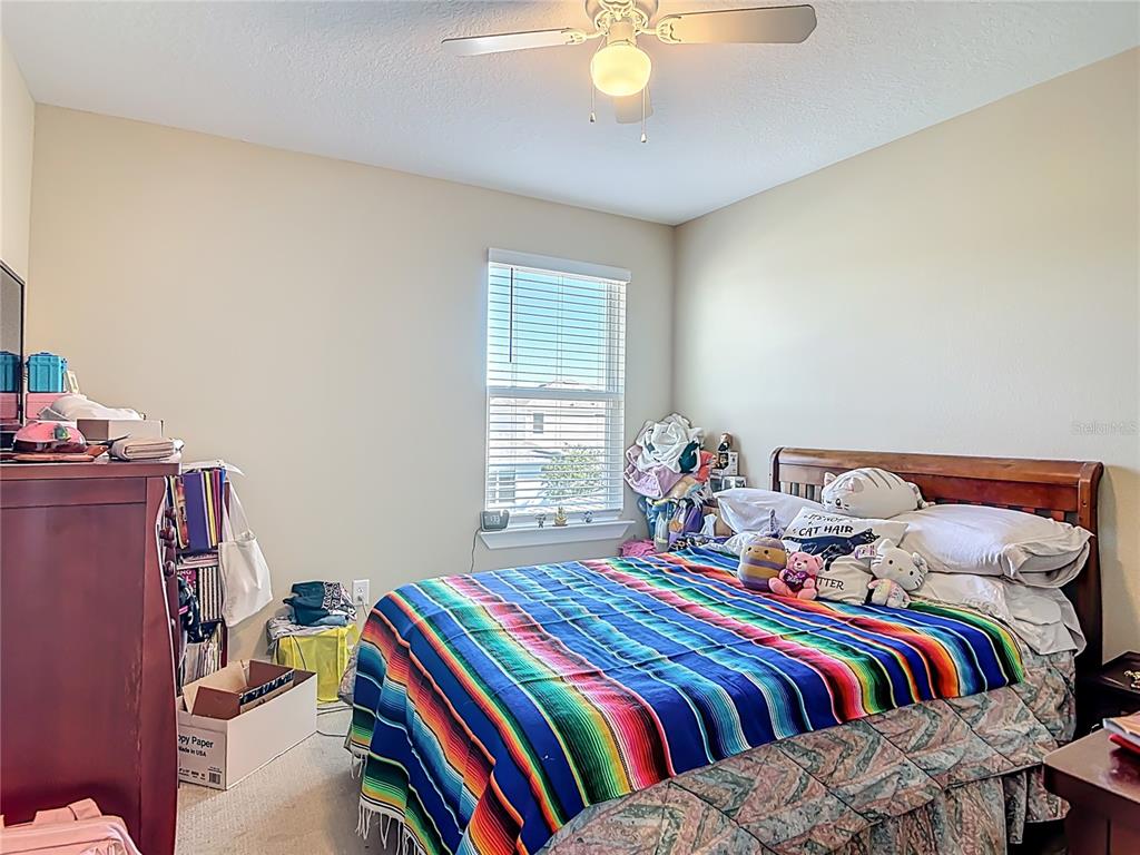 2248 Canopy Terrace Boulevard DeLand, FL 32724 - Photo 21 of 49 a bedroom with a bed and window