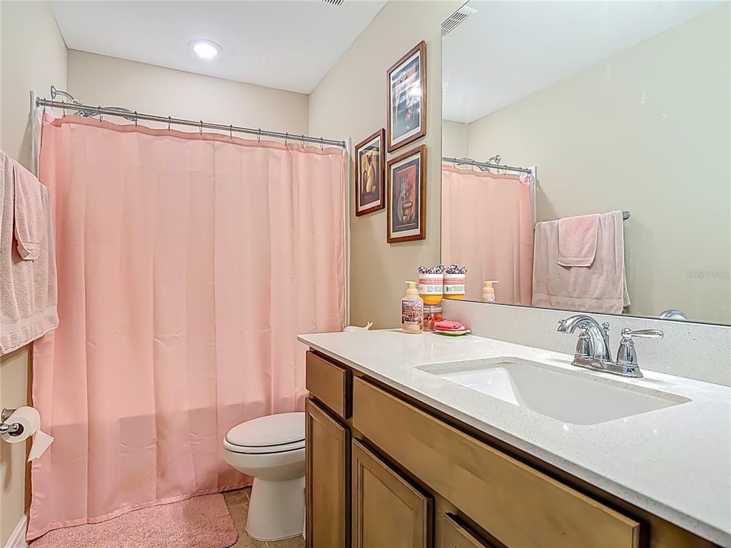 2248 Canopy Terrace Boulevard DeLand, FL 32724 - Photo 23 of 49 a bathroom with a sink a toilet and shower curtain