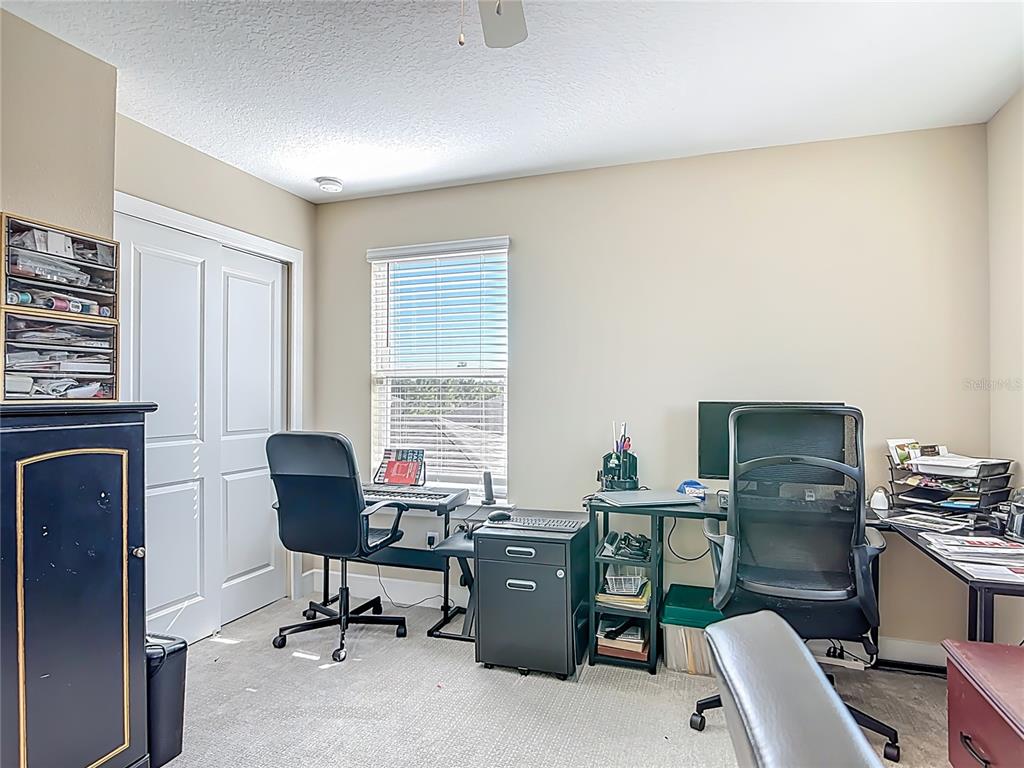2248 Canopy Terrace Boulevard DeLand, FL 32724 - Photo 25 of 49 a view of a workspace with furniture and a window