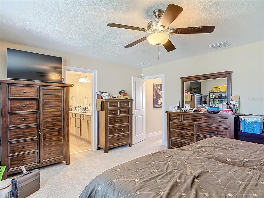2248 Canopy Terrace Boulevard DeLand, FL 32724 - Photo 28 of 49 a bedroom with furniture and flat screen tv