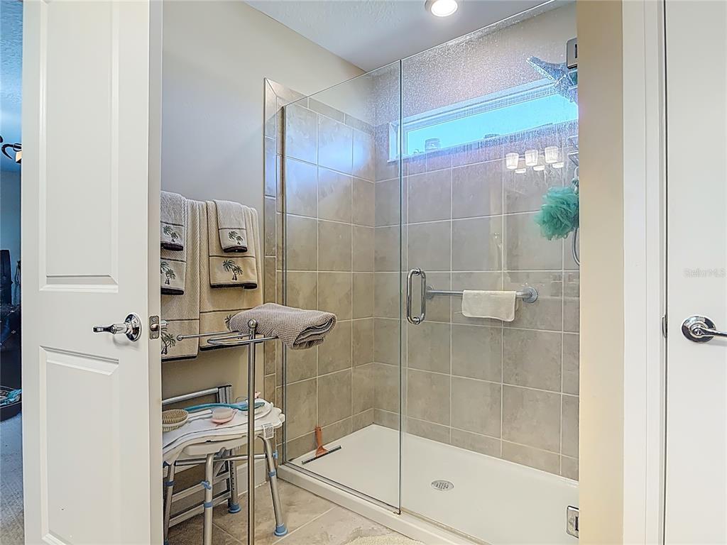 2248 Canopy Terrace Boulevard DeLand, FL 32724 - Photo 30 of 49 a bathroom with a glass shower door