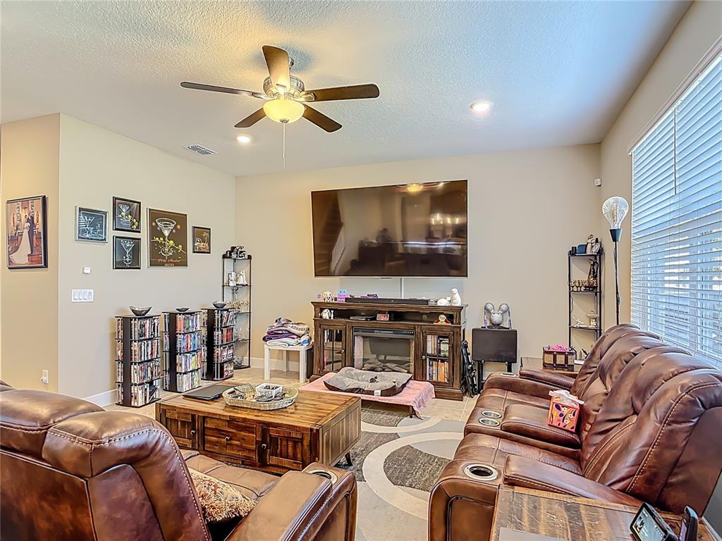2248 Canopy Terrace Boulevard DeLand, FL 32724 - Photo 7 of 49 a living room with furniture and a flat screen tv