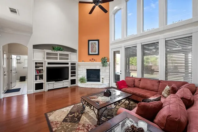 a living room with furniture fireplace and flat screen tv