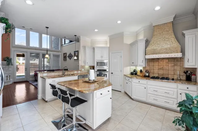 a kitchen with a sink stove and cabinets