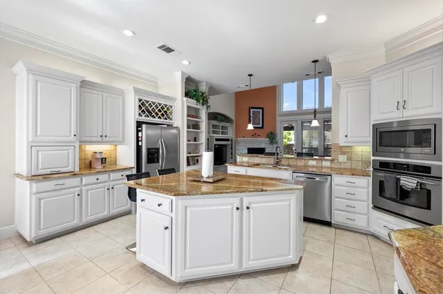 a kitchen with stainless steel appliances granite countertop a sink and cabinets