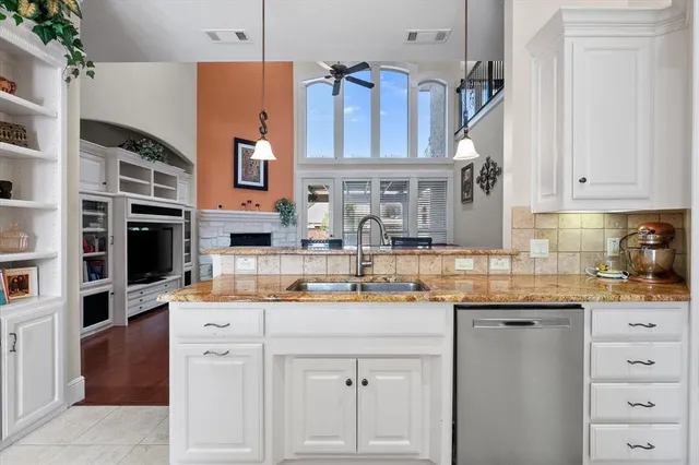 a kitchen with stainless steel appliances granite countertop a sink and cabinets
