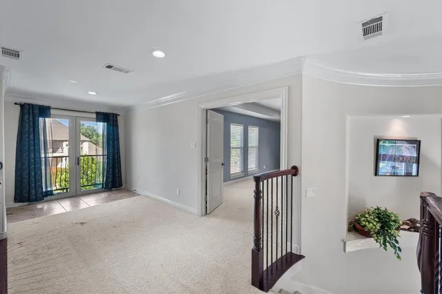a view of a hallway with wooden floor and a livingroom