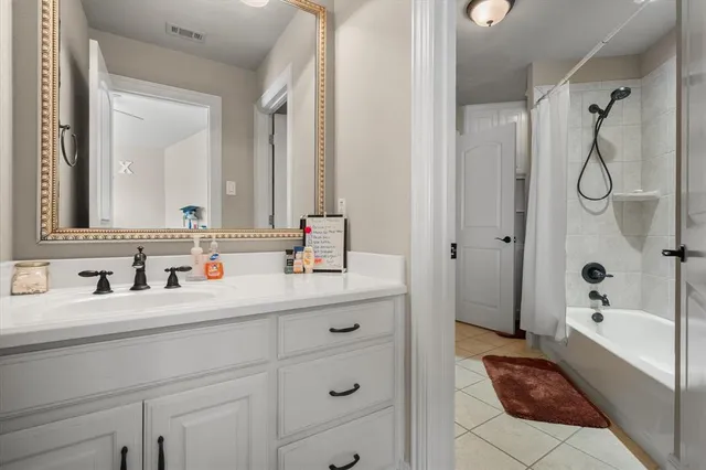 a bathroom with a double vanity sink mirror double and shower