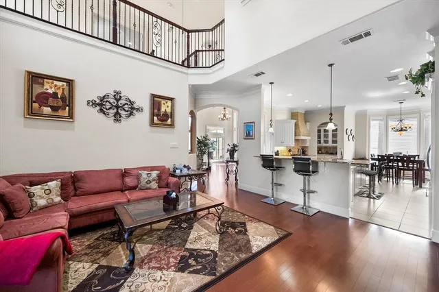 a living room with lots of furniture and view of kitchen