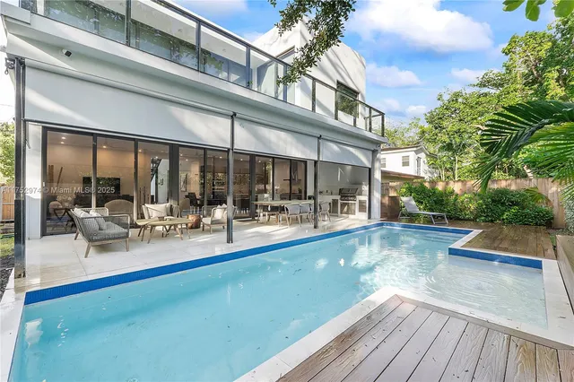 a view of a swimming pool with outdoor seating