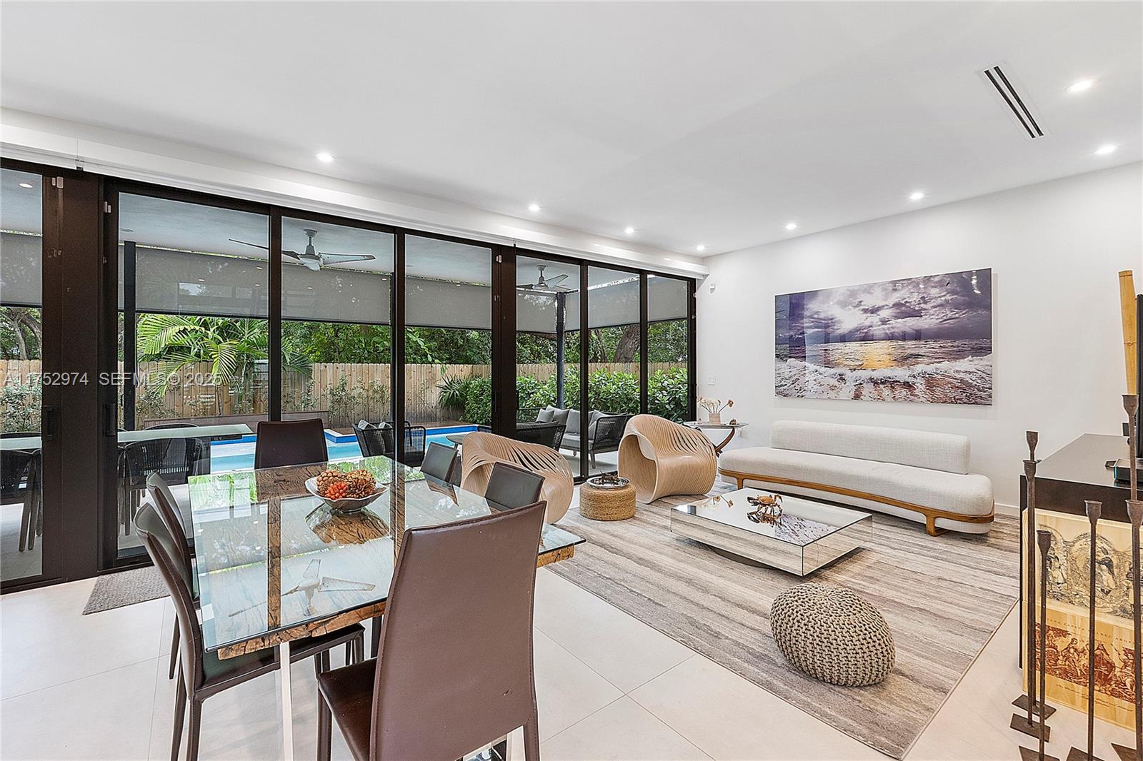 3664 Oak Avenue Miami, FL 33133 - Photo 13 of 39 a living room with furniture and a floor to ceiling window