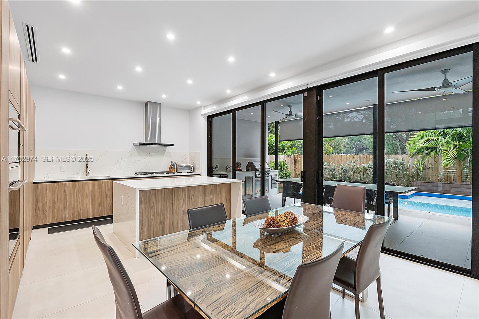 3664 Oak Avenue Miami, FL 33133 - Photo 14 of 39 a kitchen with a table chairs stove and cabinets