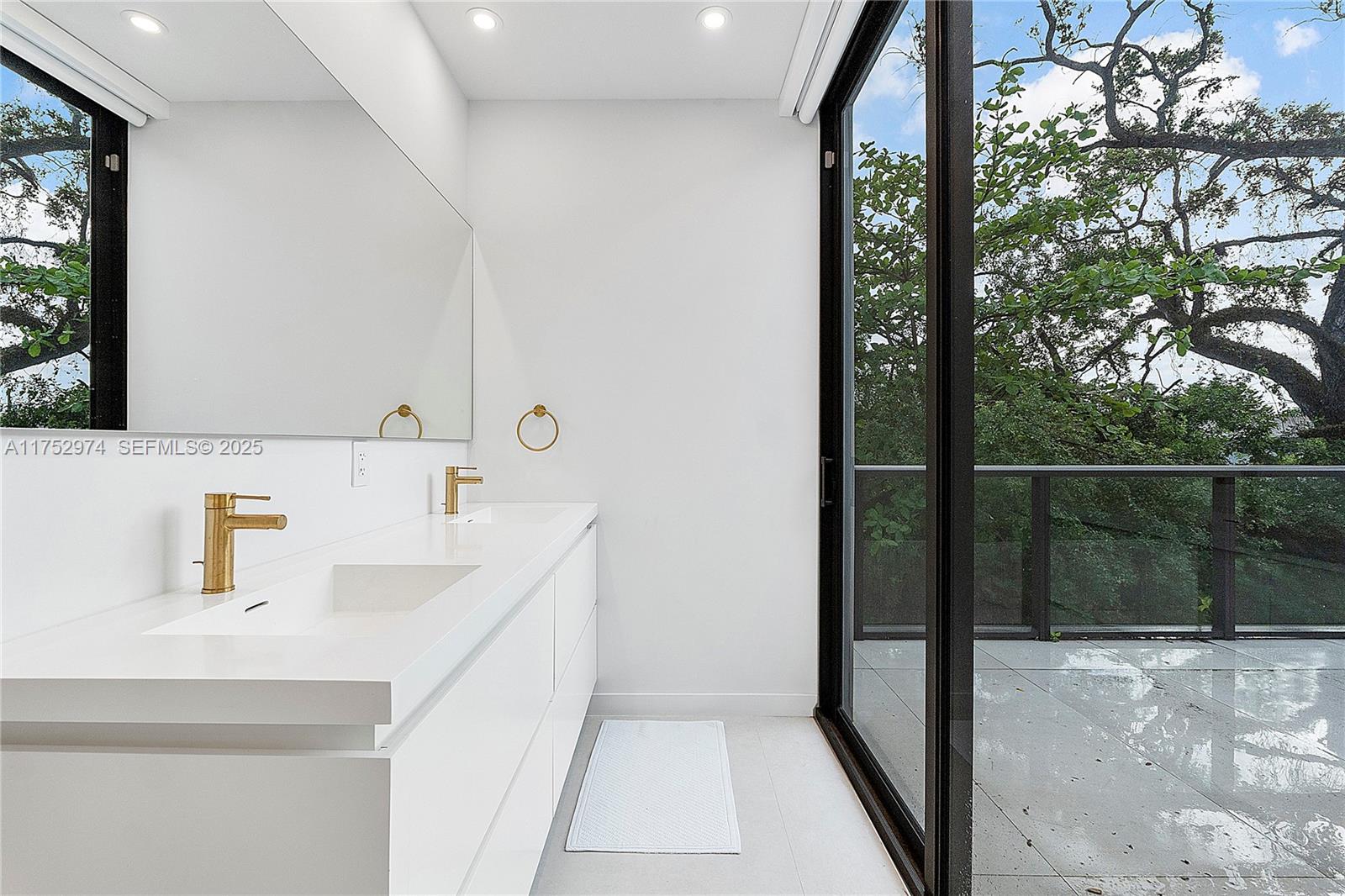3664 Oak Avenue Miami, FL 33133 - Photo 24 of 39 a bathroom with a sink and a mirror