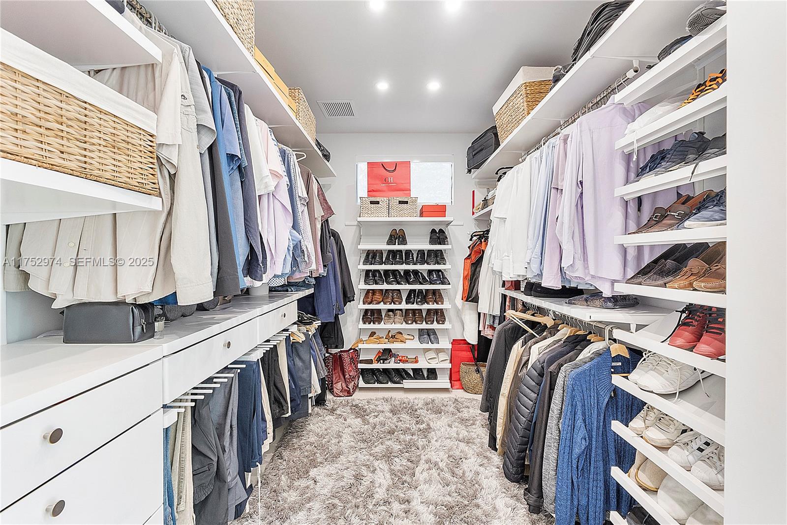 3664 Oak Avenue Miami, FL 33133 - Photo 25 of 39 a view of walk in closet with clothes and shoes