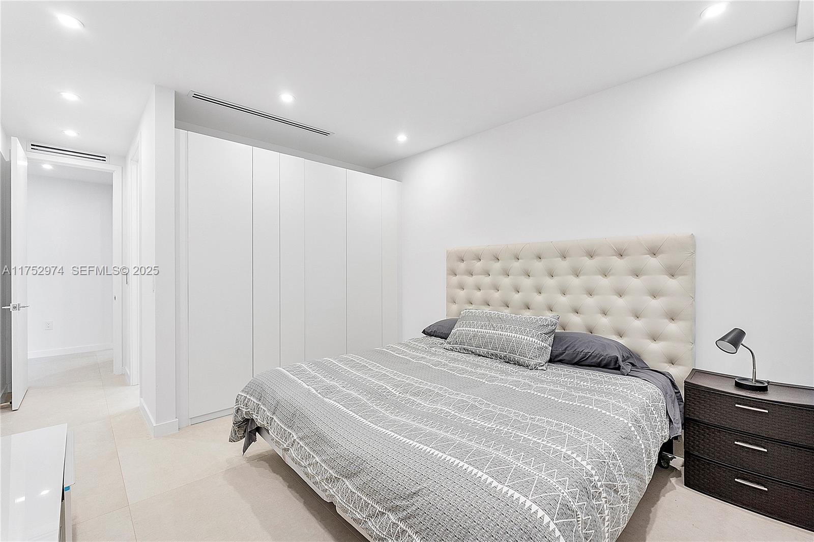 3664 Oak Avenue Miami, FL 33133 - Photo 27 of 39 a bedroom with a bed and a window