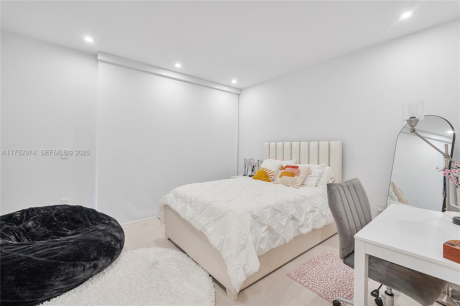 3664 Oak Avenue Miami, FL 33133 - Photo 29 of 39 a bedroom with a bed and a mirror