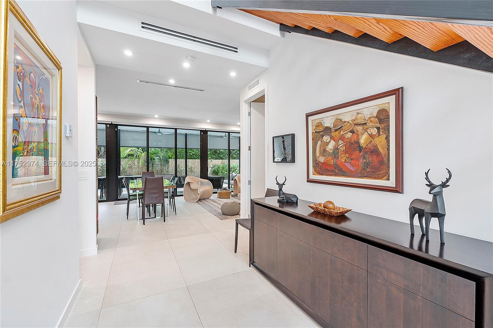 3664 Oak Avenue Miami, FL 33133 - Photo 35 of 39 a living room with furniture and a large window with outer view