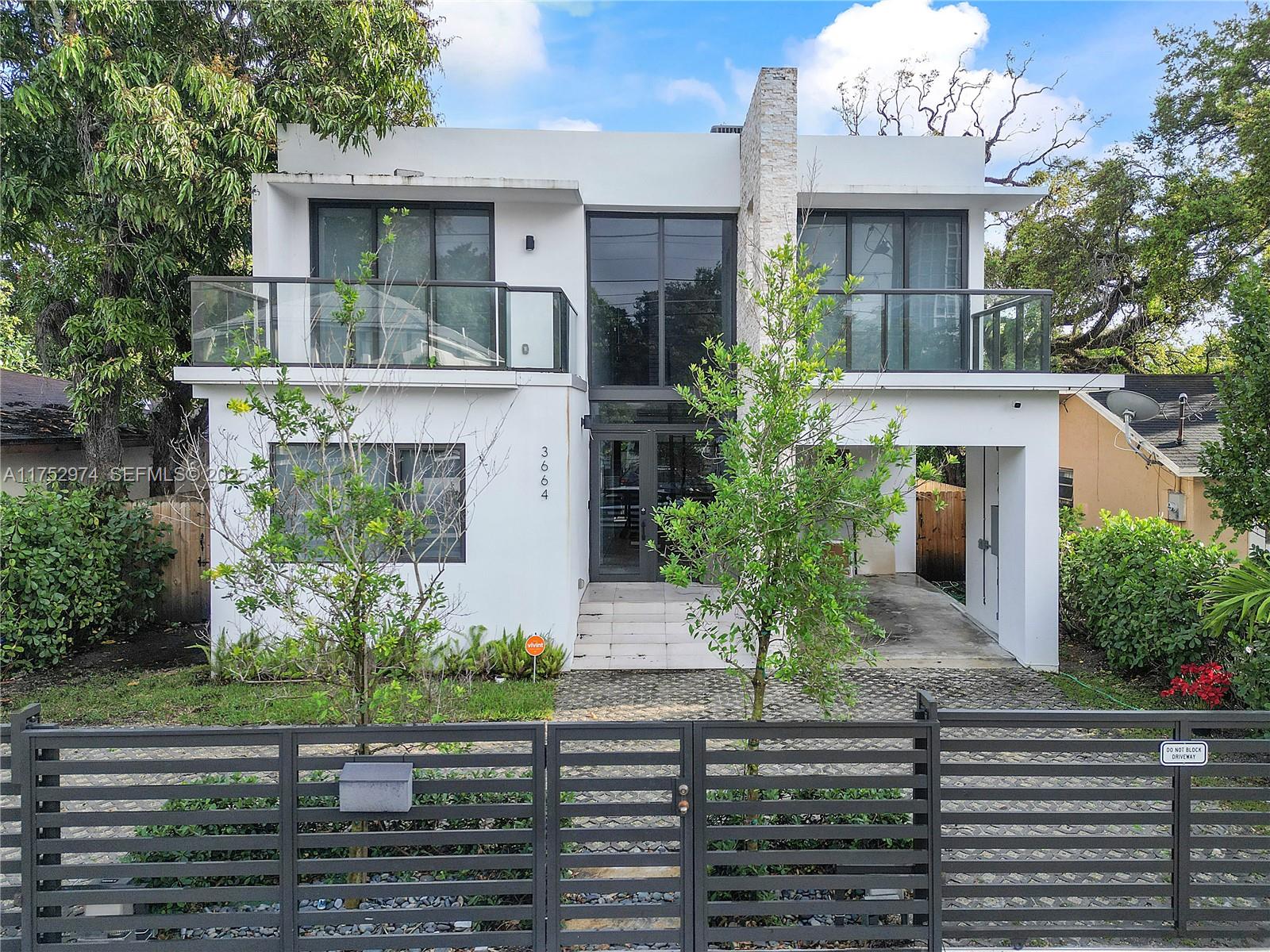3664 Oak Avenue Miami, FL 33133 - Photo 36 of 39 a front view of a house with garden