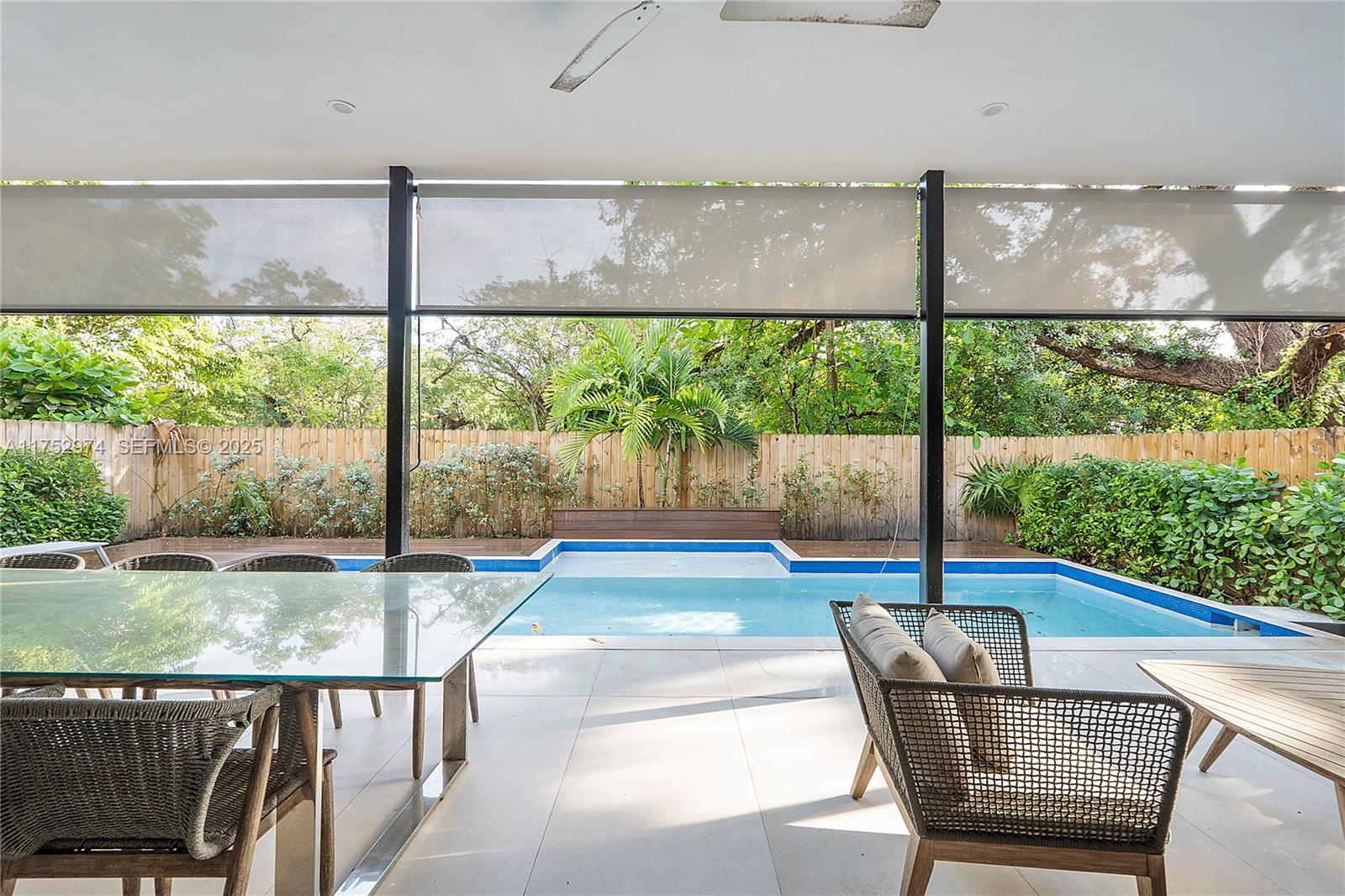 3664 Oak Avenue Miami, FL 33133 - Photo 7 of 39 a living room with a floor to ceiling window and a table