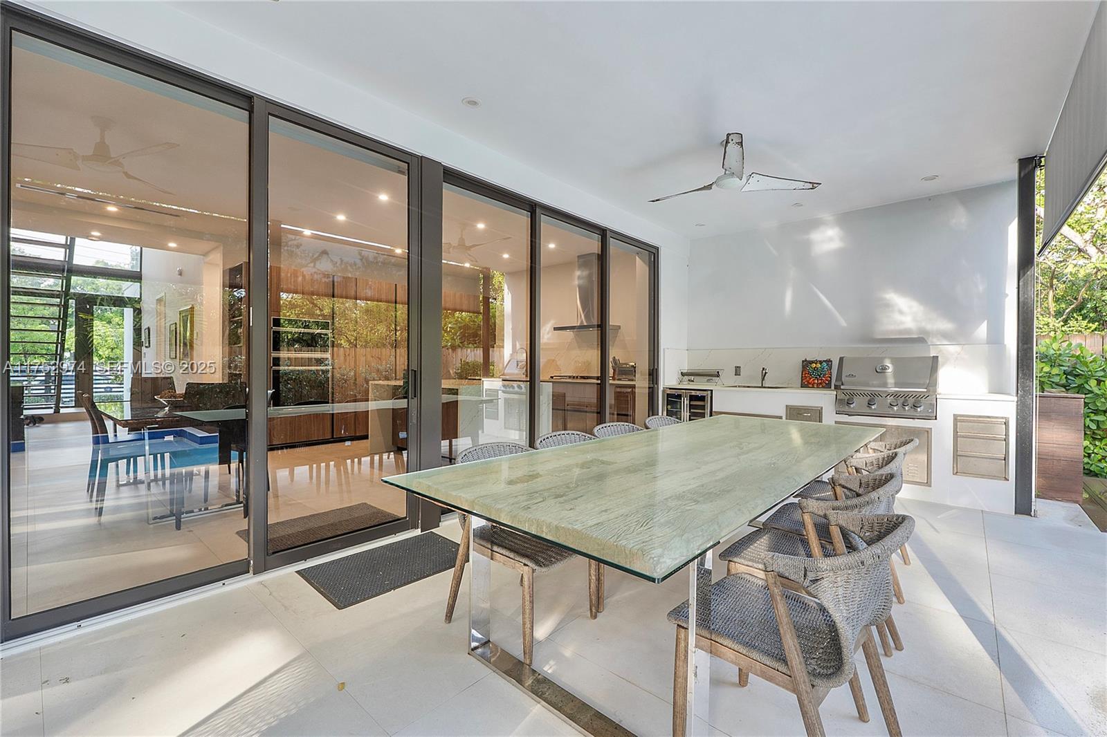 3664 Oak Avenue Miami, FL 33133 - Photo 9 of 39 a view of a dining room with furniture large windows and wooden floor