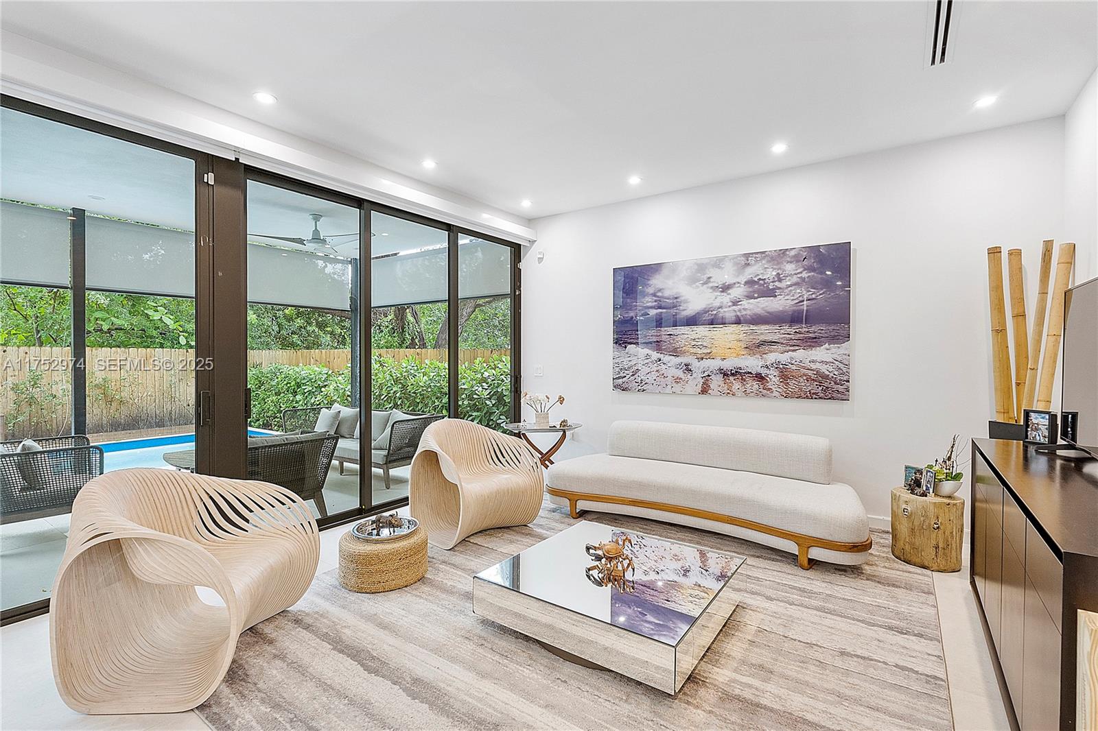 3664 Oak Avenue Miami, FL 33133 - Photo 10 of 39 a living room with furniture and a floor to ceiling window