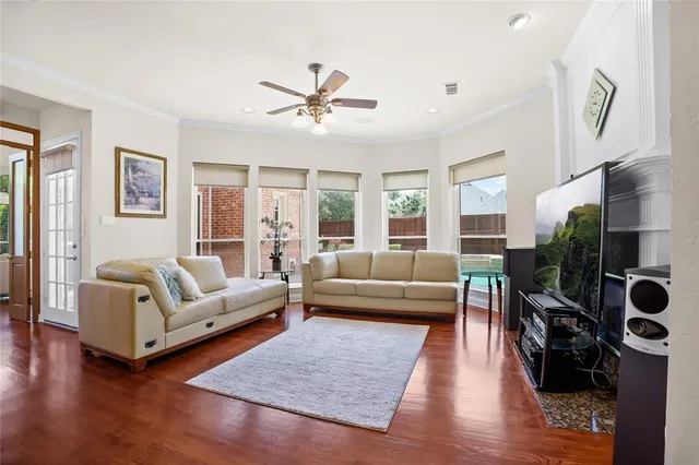 a living room with furniture and a wooden floor