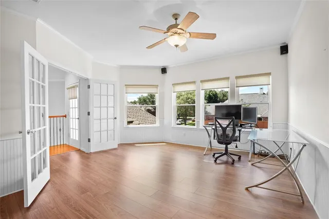 a view of a livingroom with workspace and a window