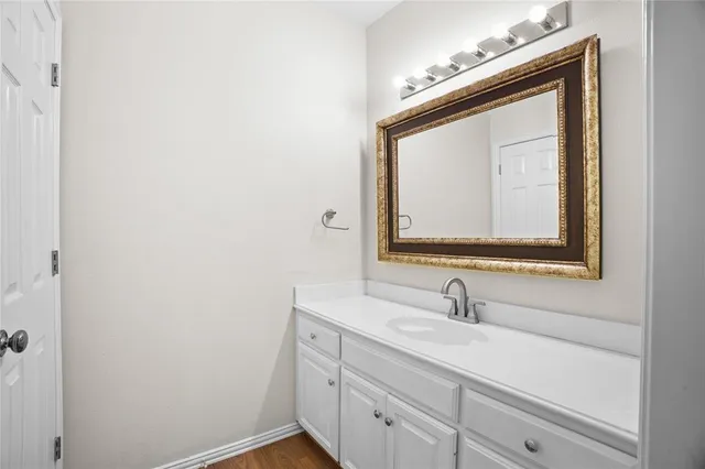 a bathroom with a sink vanity and mirror