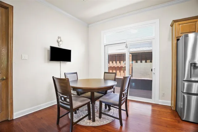 a dining room with furniture and wooden floor