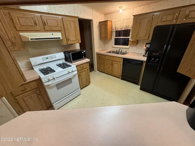 a kitchen with cabinets and a stove top oven