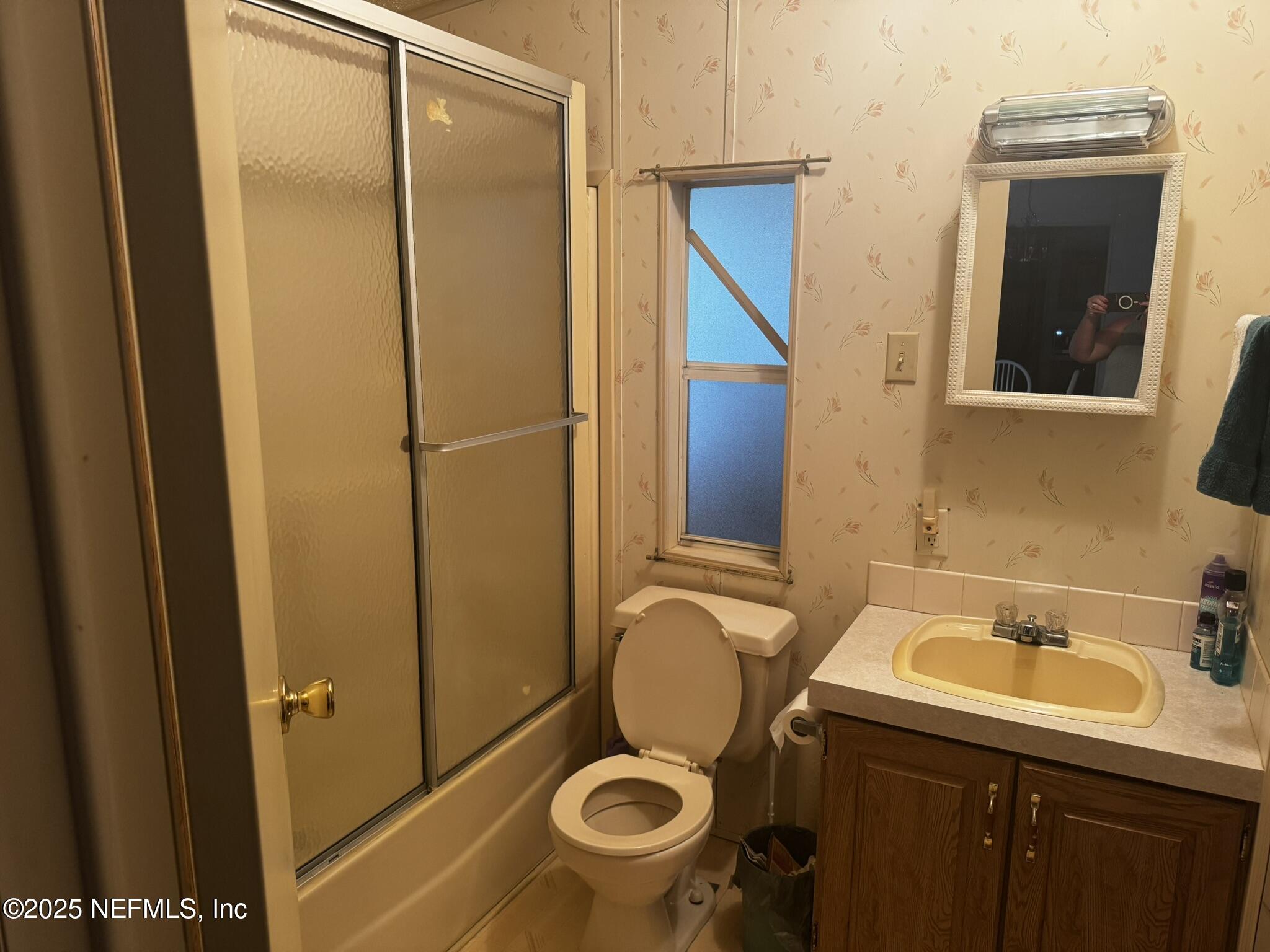 115 Edgemere Drive Georgetown, FL 32139 - Photo 18 of 24 a bathroom with a sink and mirror with toilet