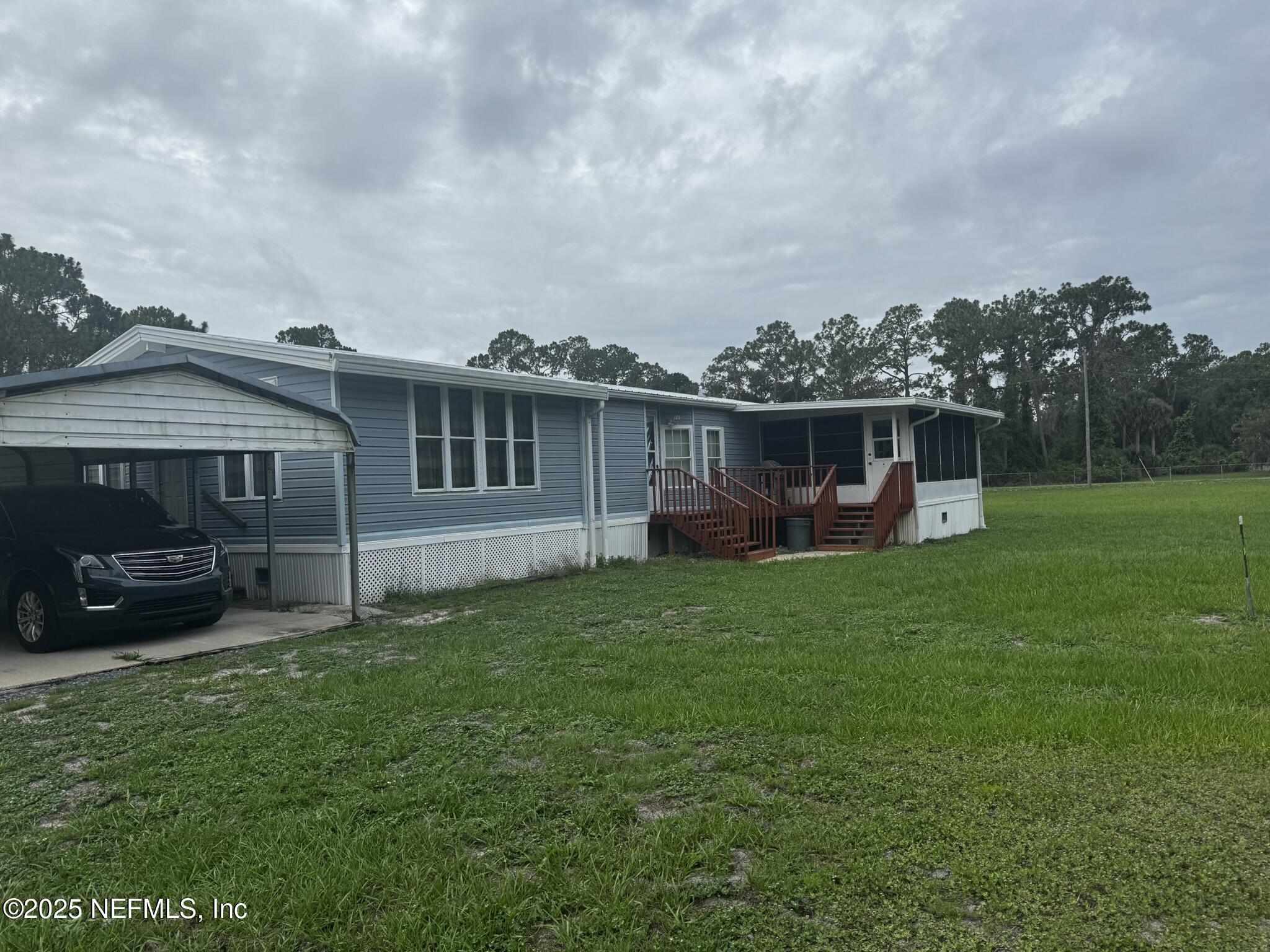 115 Edgemere Drive Georgetown, FL 32139 - Photo 2 of 24 a view of a house with backyard and a garden