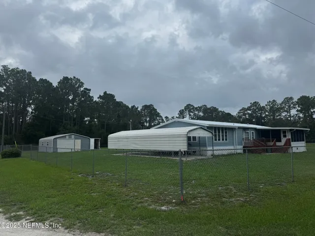 a view of a house with a garden and a yard