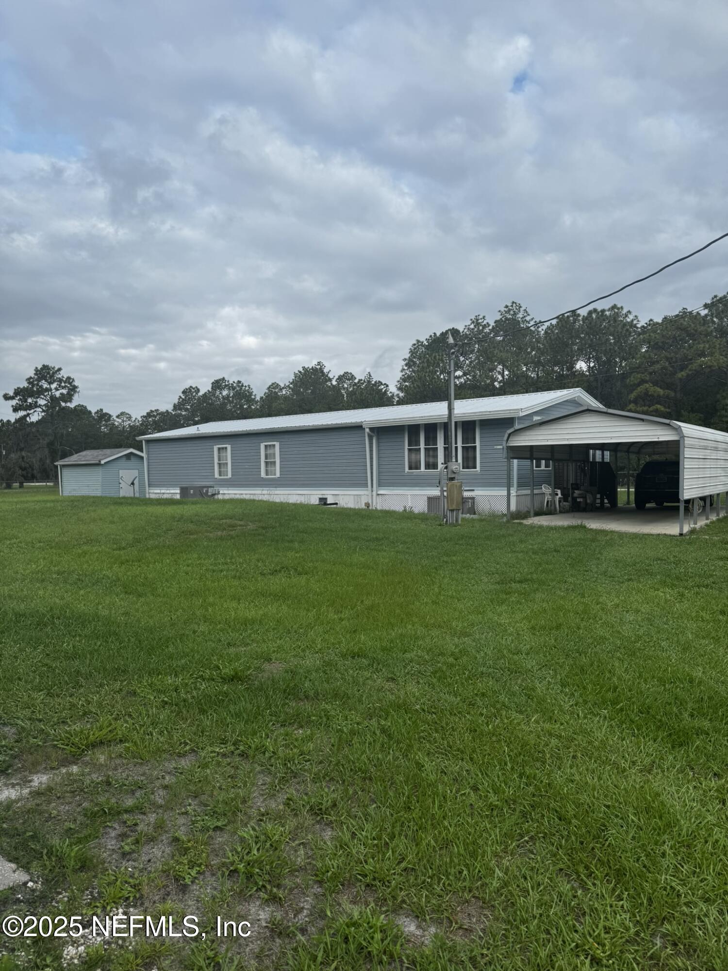 115 Edgemere Drive Georgetown, FL 32139 - Photo 4 of 24 a view of a house with a big yard and potted plants