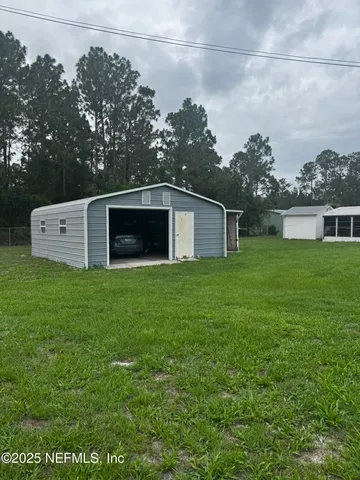 a backyard of a house with yard and trampoline