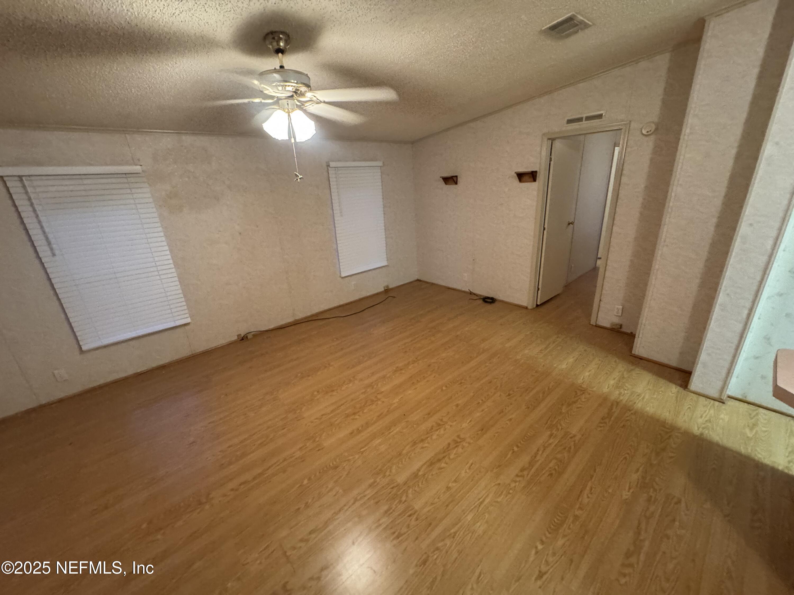 115 Edgemere Drive Georgetown, FL 32139 - Photo 10 of 24 wooden floor in an empty room
