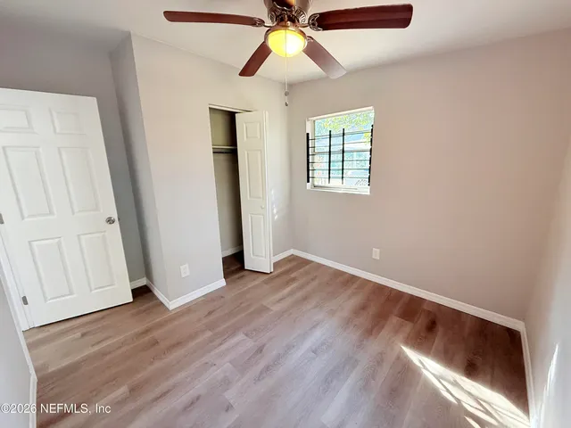 wooden floor in an empty room with a window