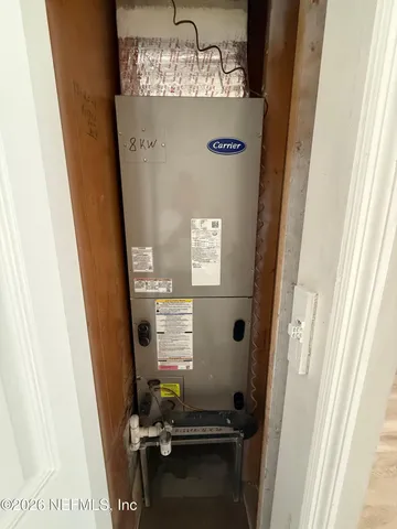 a room with water heater and car parked