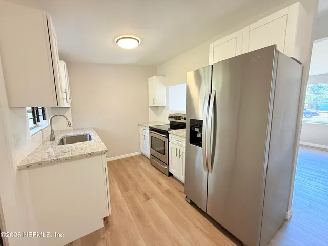 a kitchen with a refrigerator sink and stove