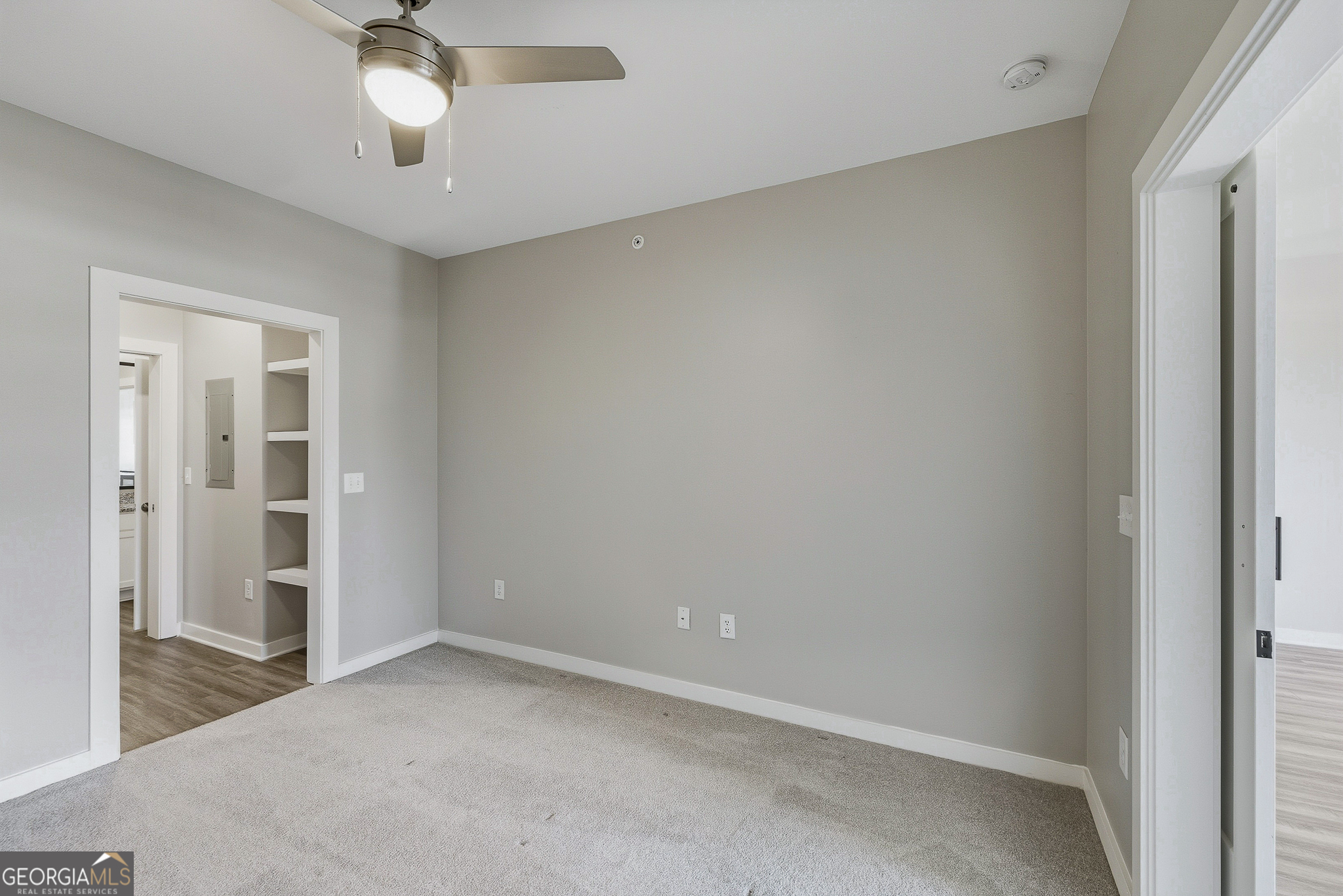 100 Prince Avenue, Unit A303 Athens, GA 30601 - Photo 18 of 27 an empty room with a chandelier fan and closet