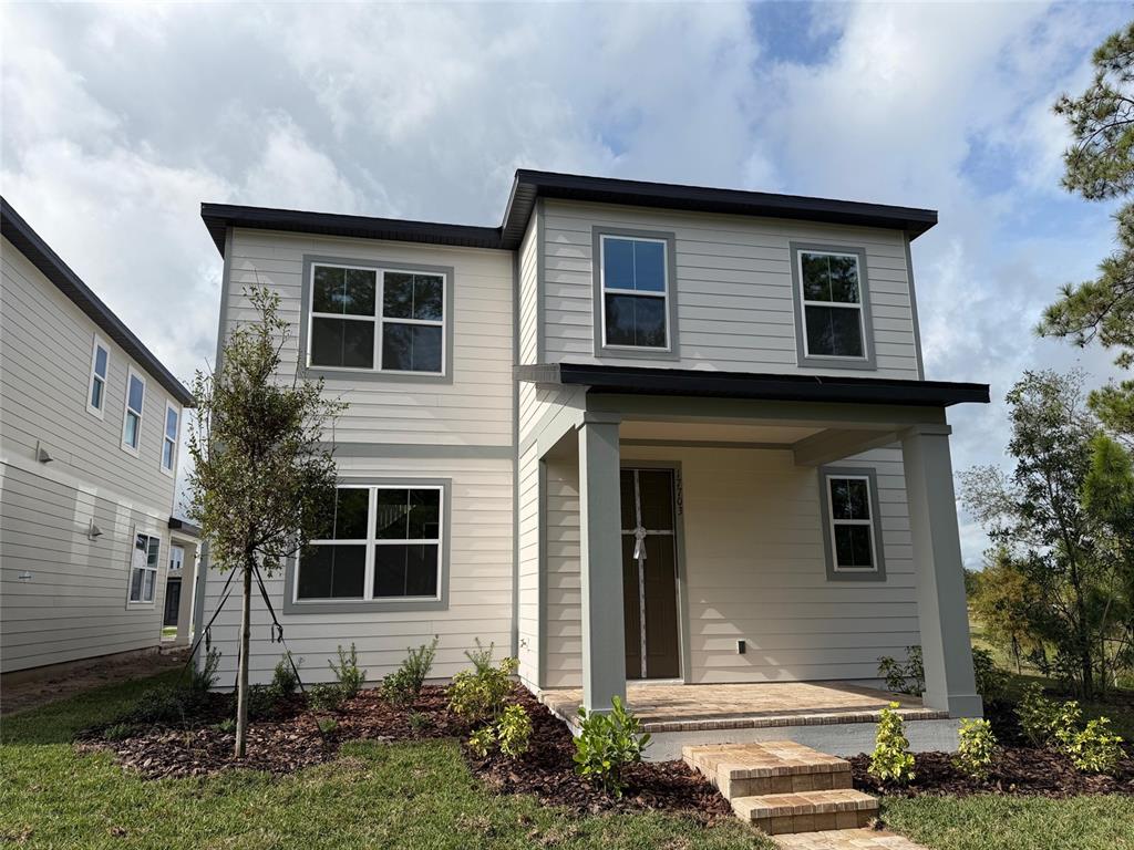 a front view of a house with a yard garage and outdoor seating