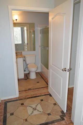 a bathroom with a toilet and a shower