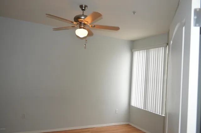 a view of a room with a window and a fan